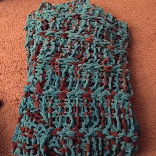 Wonderful crocheted lap blanket in teal and brown.