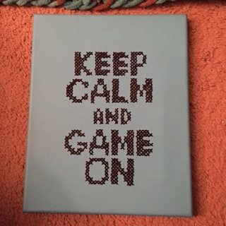 Painted canvas with cross stitch on it! I thought this was clever.