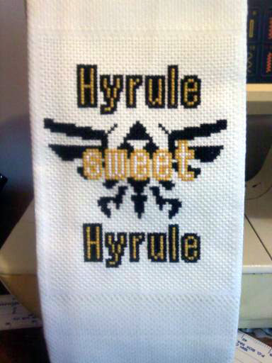 A towel with the Hyrulian royal crest and Hyrule sweet Hyrule on it.